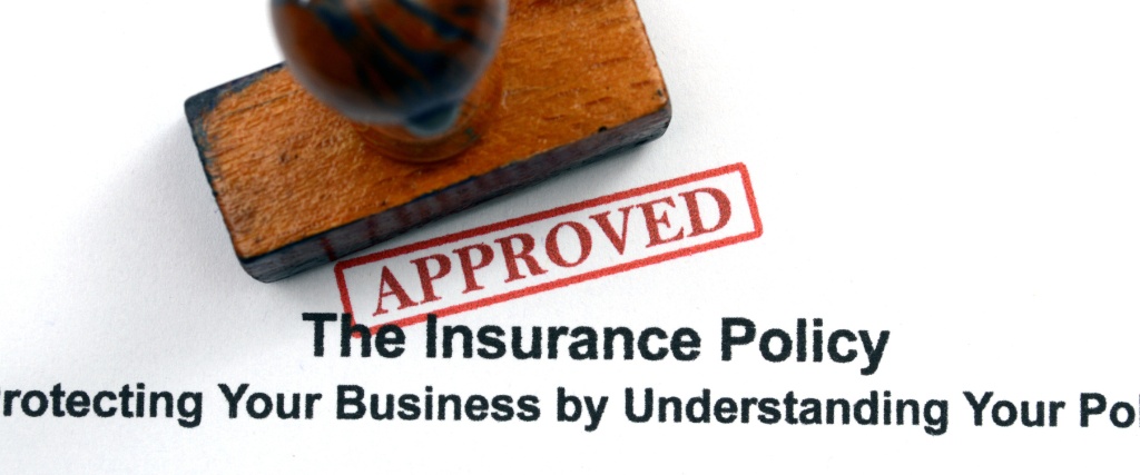 Why ANSI A300 Pruning Standards Matter for Tree Health and Property Value 2 An insurance policy document with an "APPROVED" rubber stamp, illustrating the importance of proper documentation for tree care services.