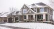 An upscale Bergen County home with mature trees in the front yard during winter, showing well-maintained landscaping that adds property value.